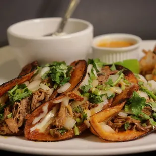 a plate of food with a bowl of sauce