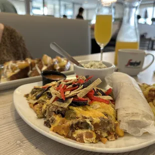 a plate of food and a glass of orange juice