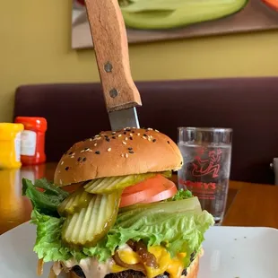 a knife stuck in a burger