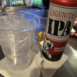 a can of laguntas and a glass of water
