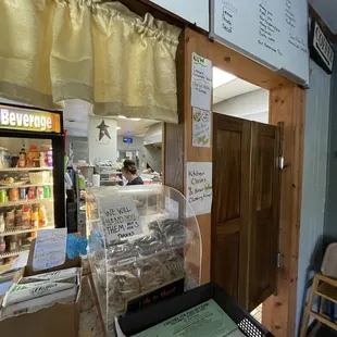 The front cashier right in front of the open kitchen.