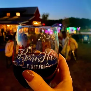 a hand holding a glass of wine