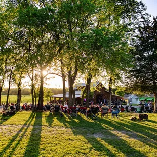 More seating at the tree line which is strung with lights and provides  some shade.