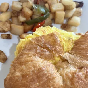 Classic Croissant Sandwich (Egg &amp; Cheese on a croissant) with a side of home fries.