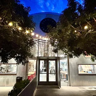 the front entrance of a restaurant at night