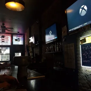 a man sitting at a bar in front of a television