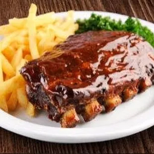 a plate of ribs and french fries