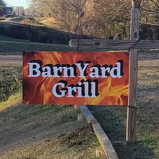 a barnyard grill sign