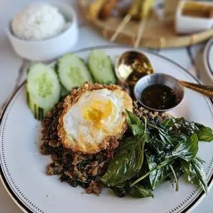 Pad Ga Pow ($16) with proper ground pork and lots of basil topped with a true Thai style fried egg with crispy edges and runny yolk