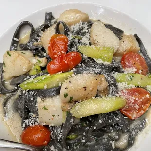 a plate of pasta with vegetables