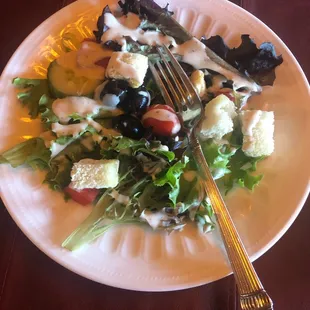 a plate of salad with a fork