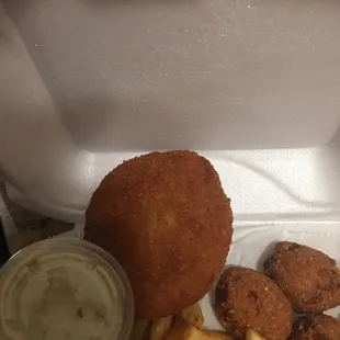 Small crab cake and overdone hush puppies