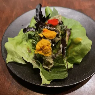 a plate of salad on a wooden table