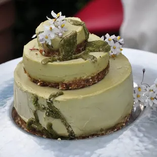 a three tiered cake with flowers on top