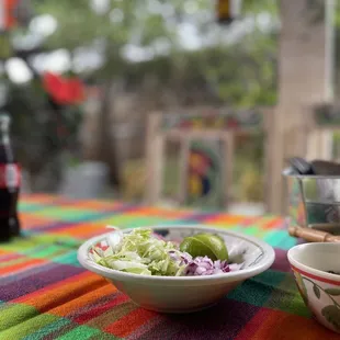 a bowl of salad and a bowl of pickles