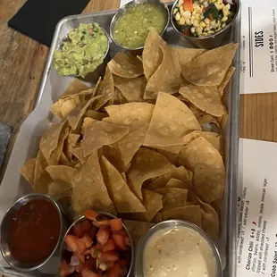Chips, salsas, corn queso, guacamole