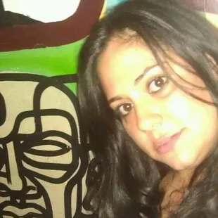  woman in front of a graffiti wall