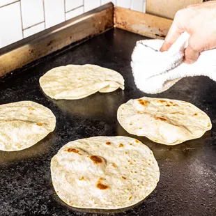 a person cleaning tortillas