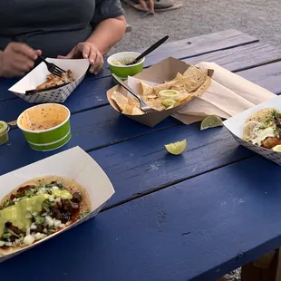 a woman sitting at a picnic table