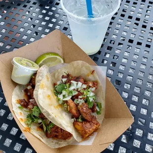 Chicken and pork tacos with margarita.