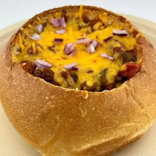 a bowl of chili cheese bread