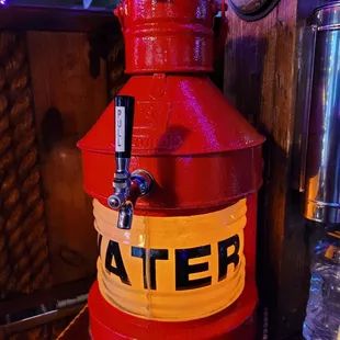 a red and yellow water jug