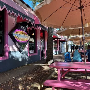 pink picnic tables and umbrellas