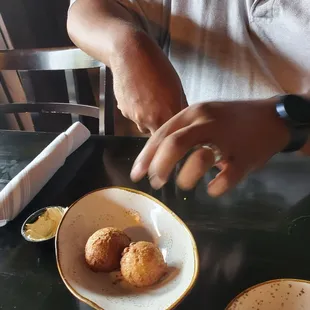 a plate of food and a person&apos;s hand