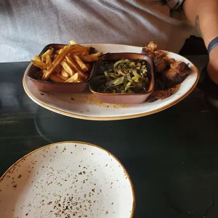 a man sitting at a table with a plate of food