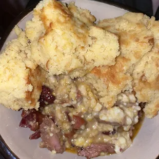 Pork with sausage Gravy and cornbread on top