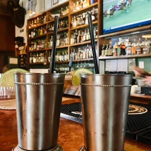 two metal cups on a bar