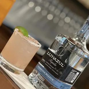 a bottle of gin and a margarita