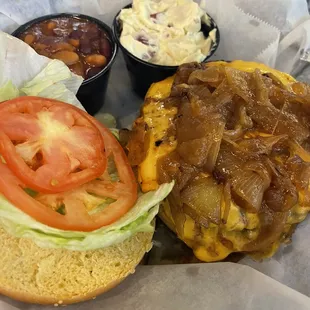 Burger with onions, potato salad, beans