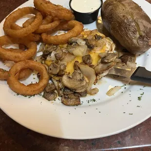 Smothered chicken entree plus $2.00 up charge for the onion rings.
