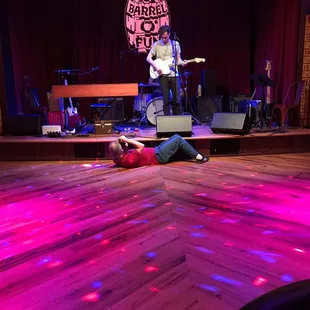  man laying on the dance floor