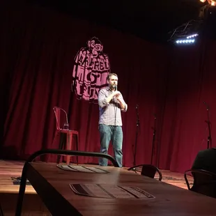  man standing on a stage with a microphone