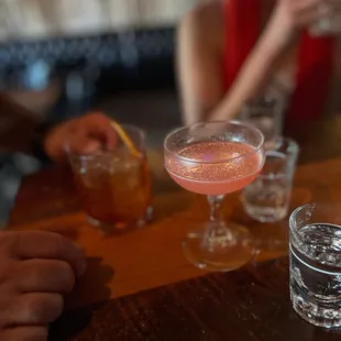 people sitting at a bar with drinks