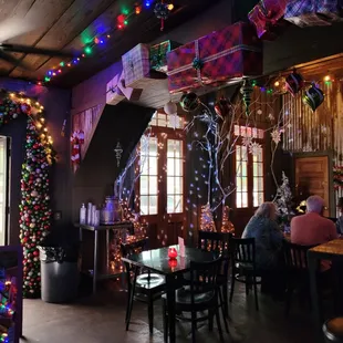 the interior of a restaurant decorated for christmas