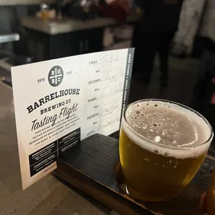 a glass of beer and a menu