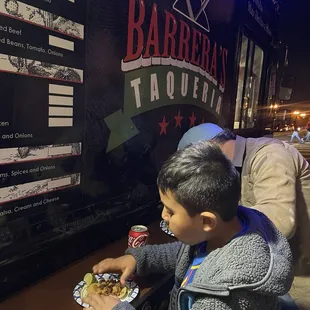 Santino enjoying his tacos at Barrera' Taqueria