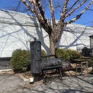 a barbecue grill in front of a building
