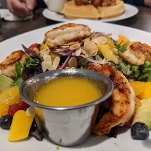 Mango and mandarin salad up front, chicken and waffles in the background