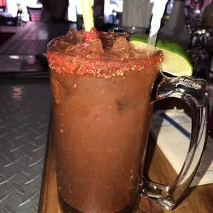 a bloody drink with a lime slice on the rim