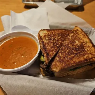 a grilled cheese sandwich and a bowl of soup