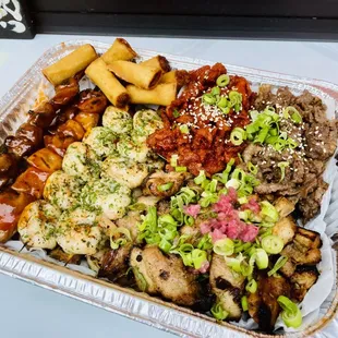 a tray of food with meat and vegetables