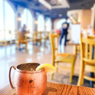 a copper mug with a lemon wedge on the rim