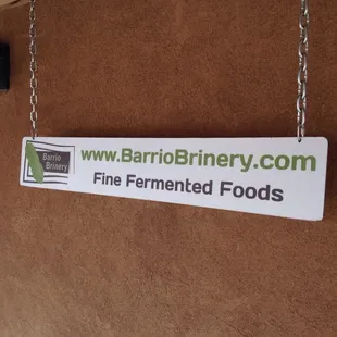 a sign hanging on a wall