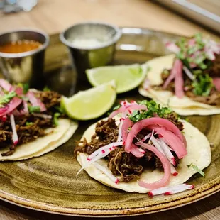 three tacoss on a plate