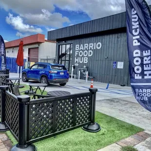 a blue car parked in front of a building