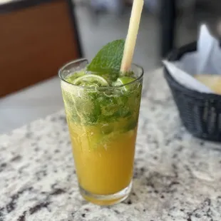a glass of mojit with a straw